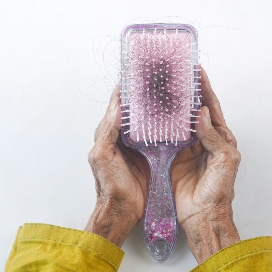 a person holding a hair brush in their hands