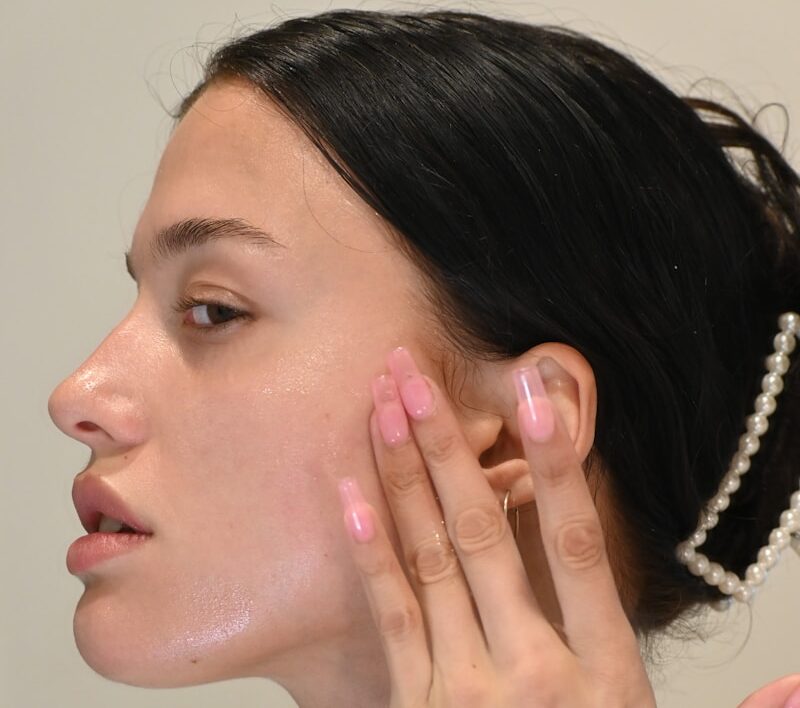 a woman with her hand on her face